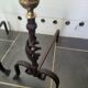 Old pair of wrought iron pegs with brass pine cone