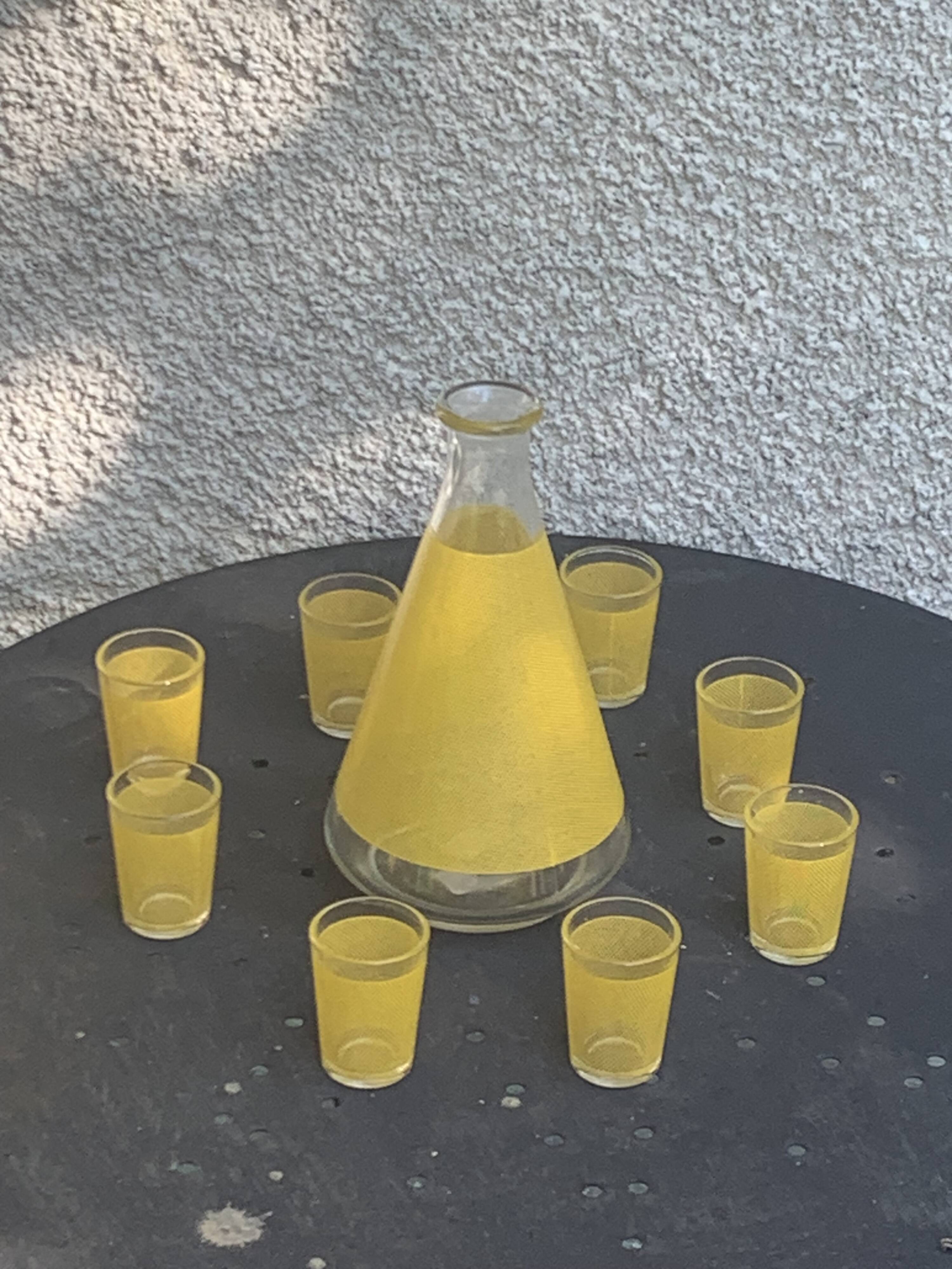 Liqueur set consisting of a glass carafe and 8 small yellow glasses