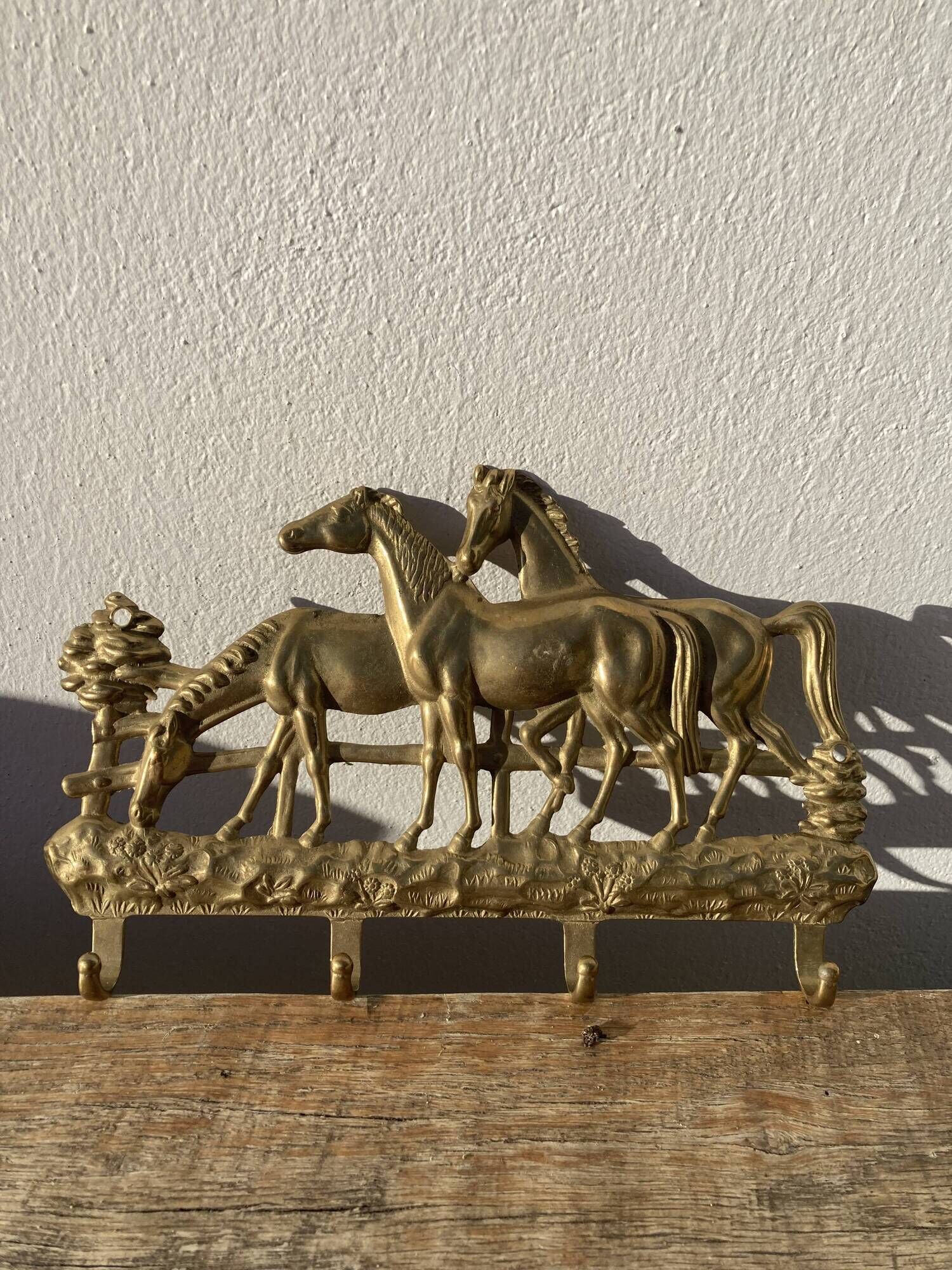 Hook for keys or tea towels in gilded brass with carved horse decoration