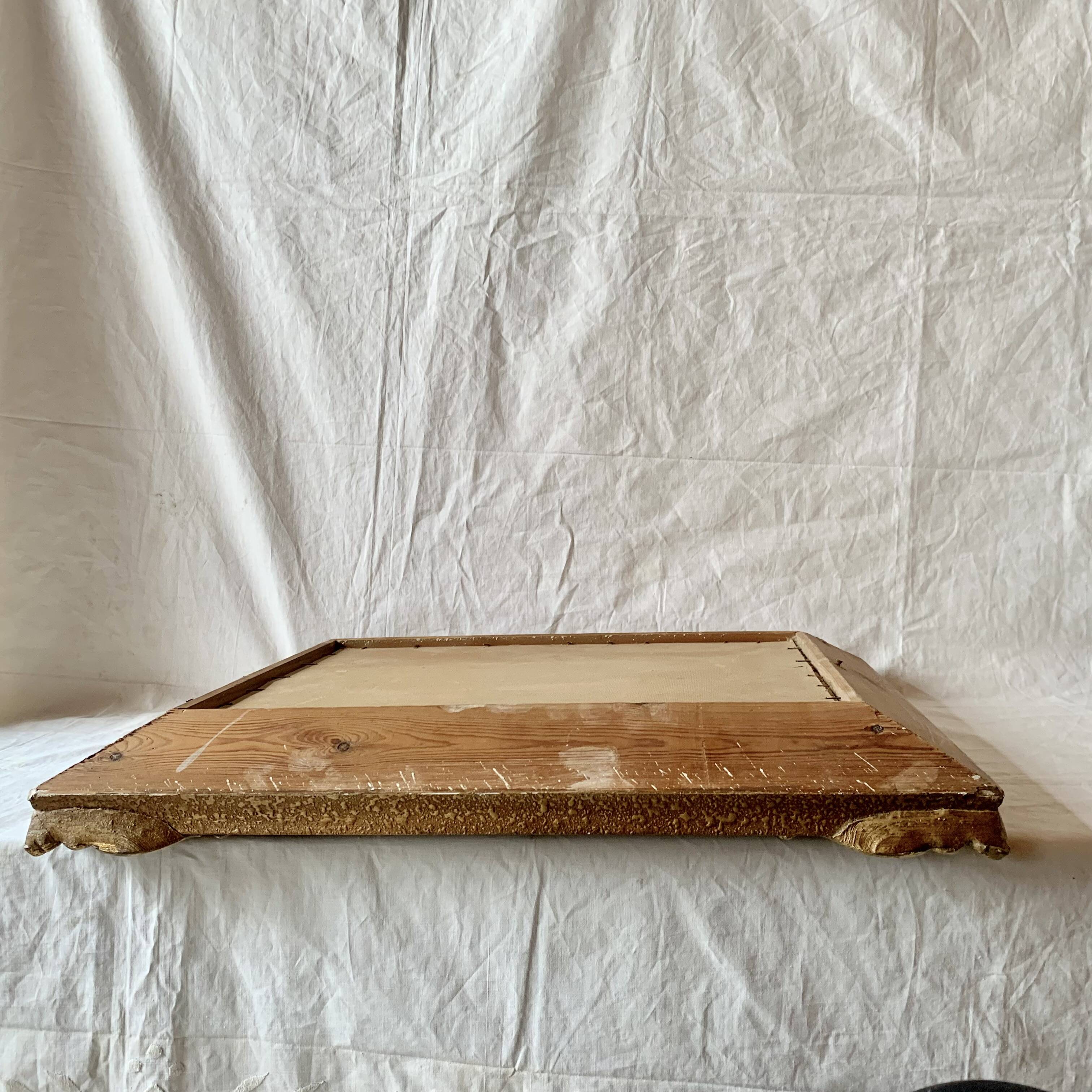 Old wall frame in carved gilded wood