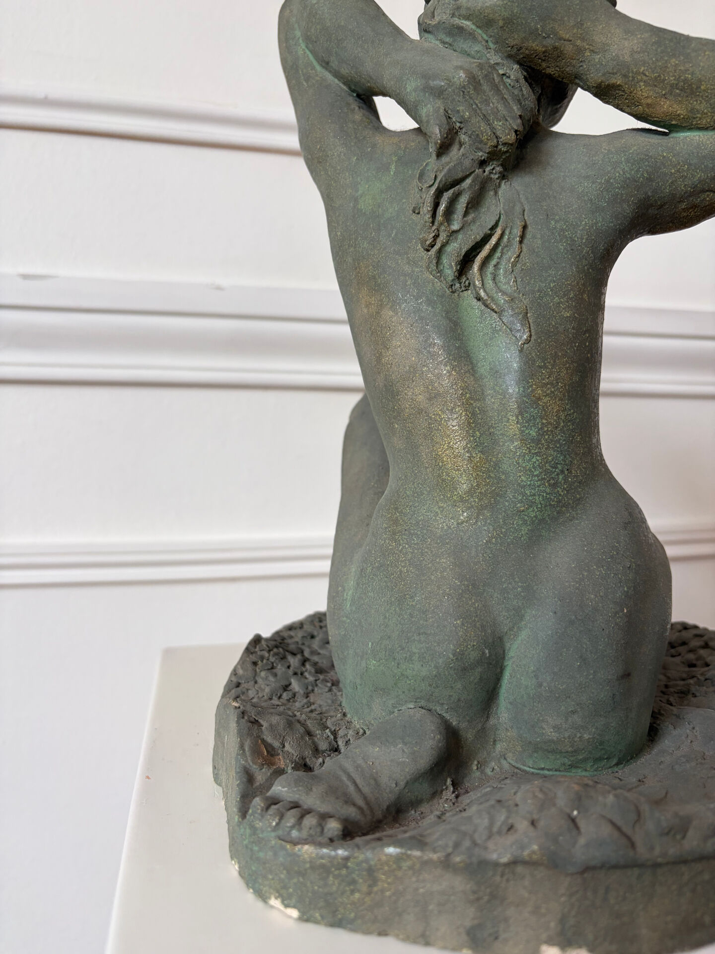 Sculpture of a naked woman titled "Youth" in terracotta.
