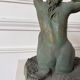 Sculpture of a naked woman titled "Youth" in terracotta.