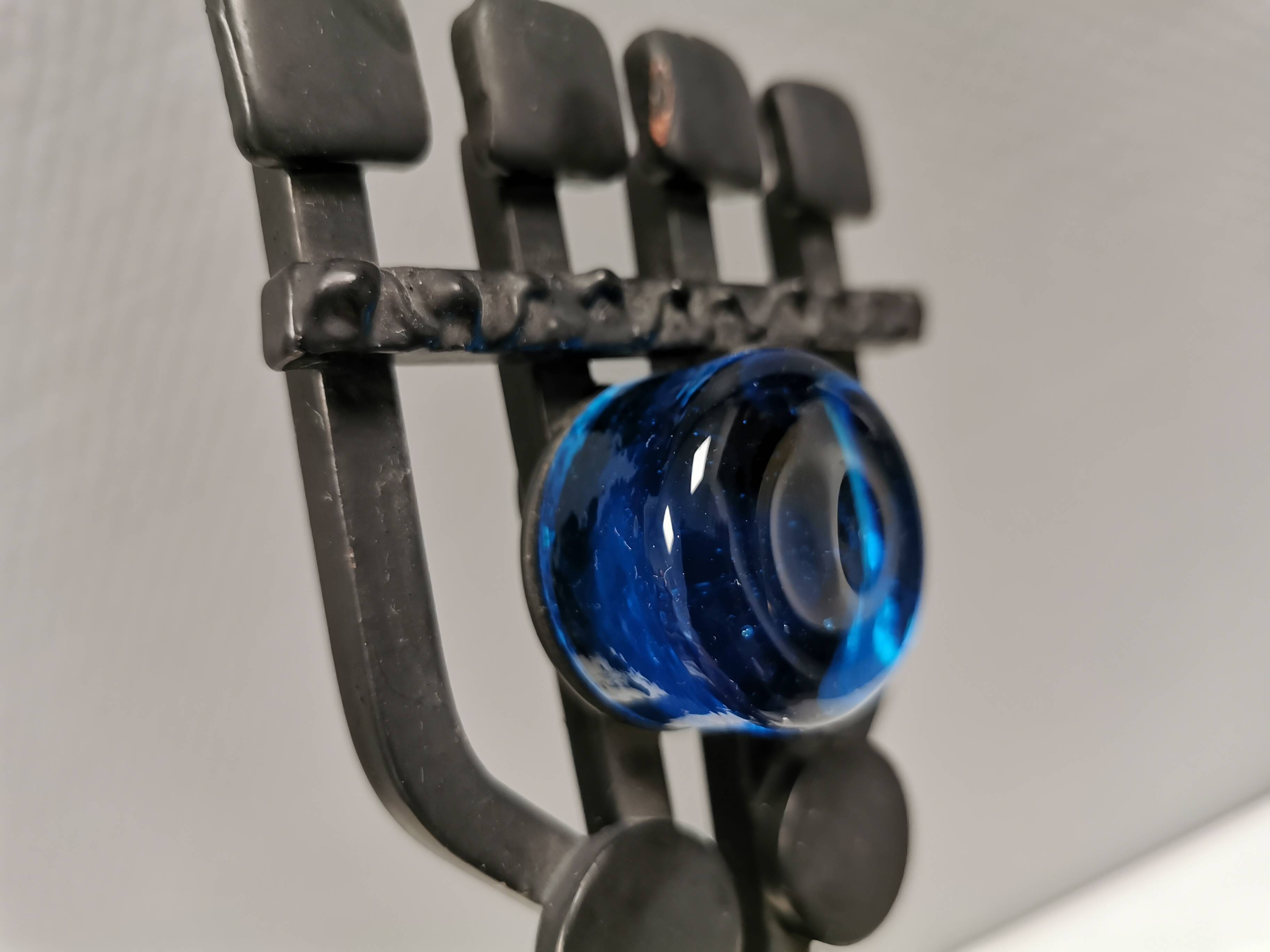 Vintage wall candle holder in wrought iron and hard pressed blue glass.