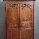 Louis XIV period wardrobe in solid oak, decorated with superb carvings
