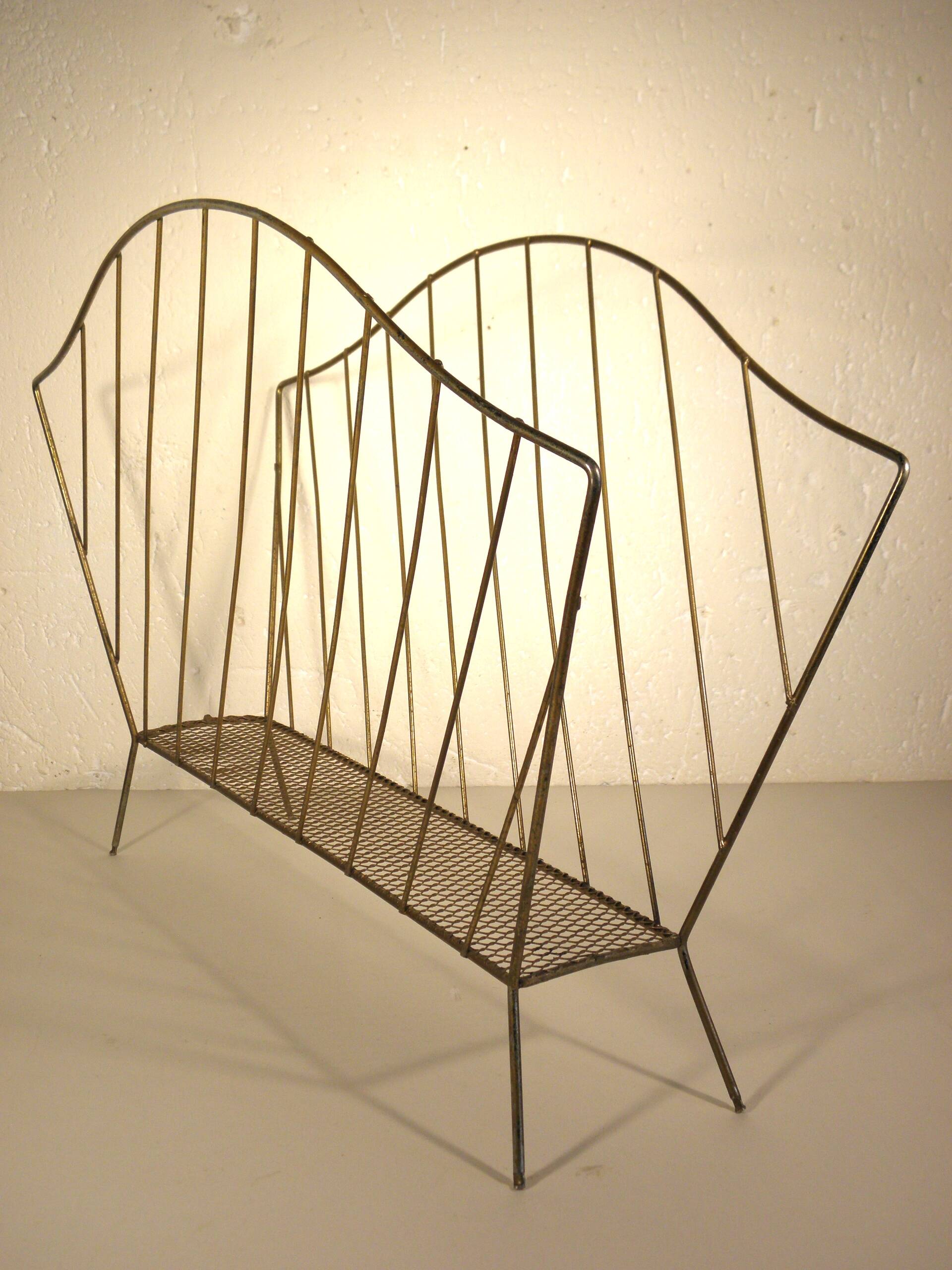 Golden metal magazine rack from the 60s