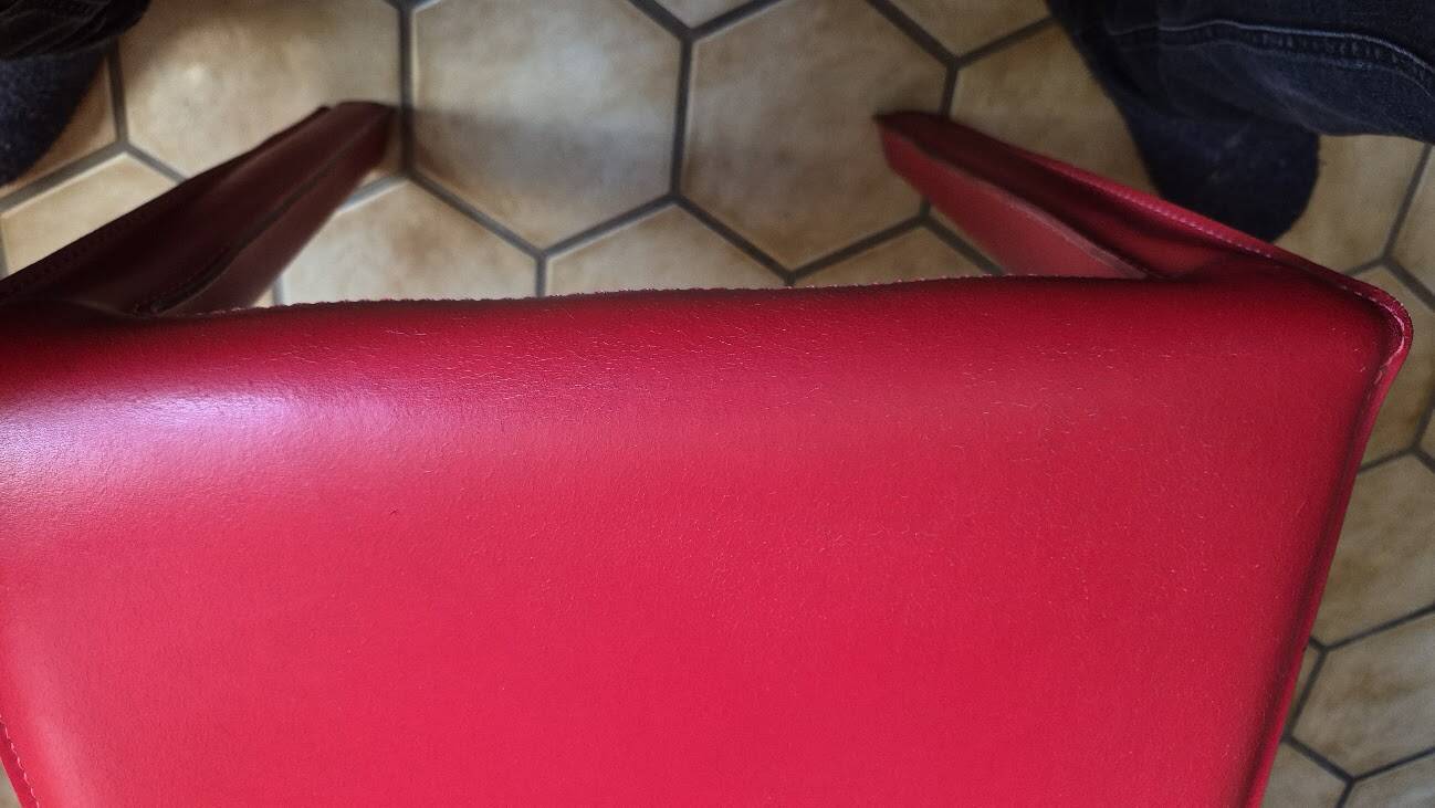 Red leather dining chairs by Arper