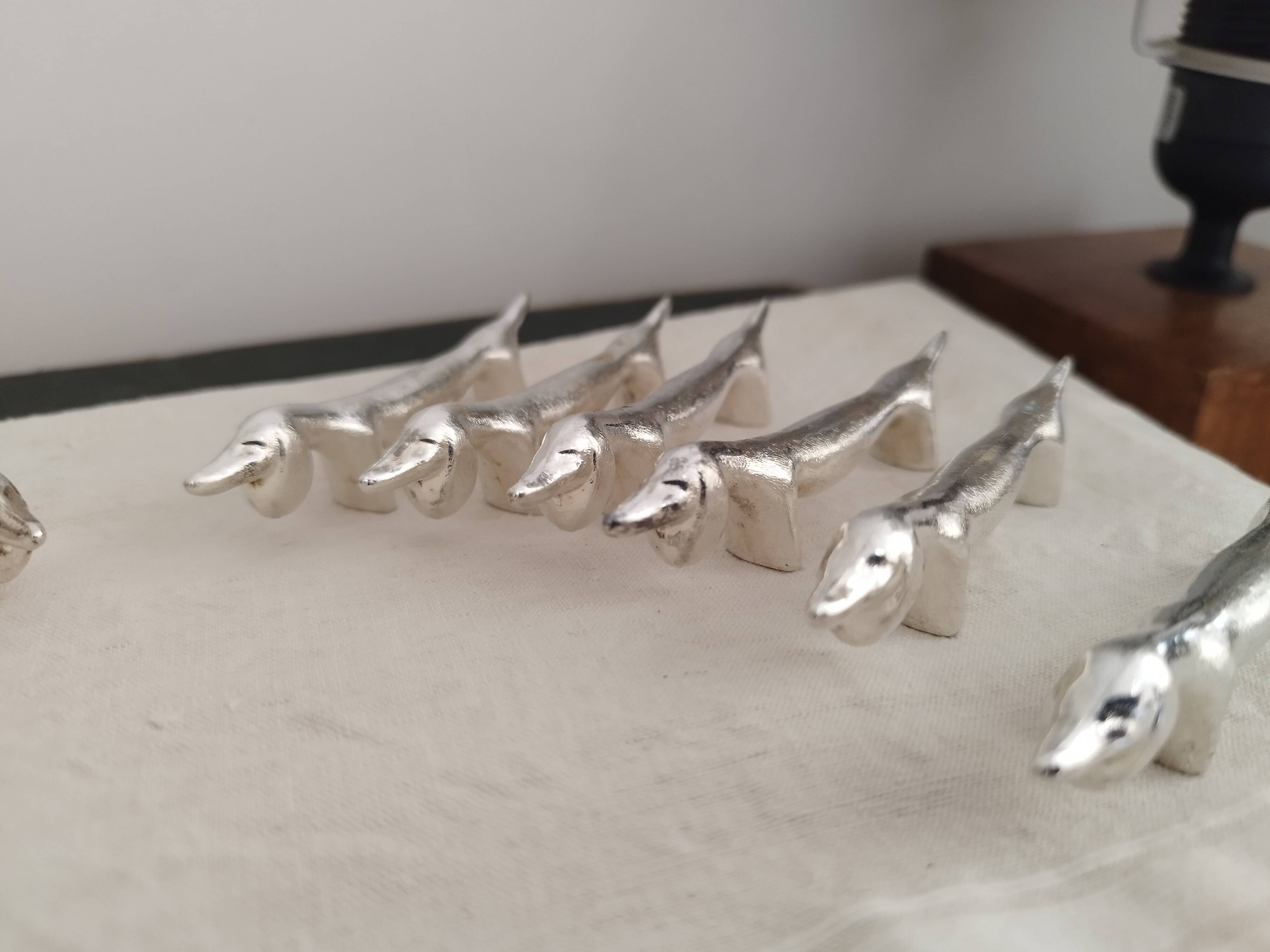 Silver metal knife holders with Dachshund dogs