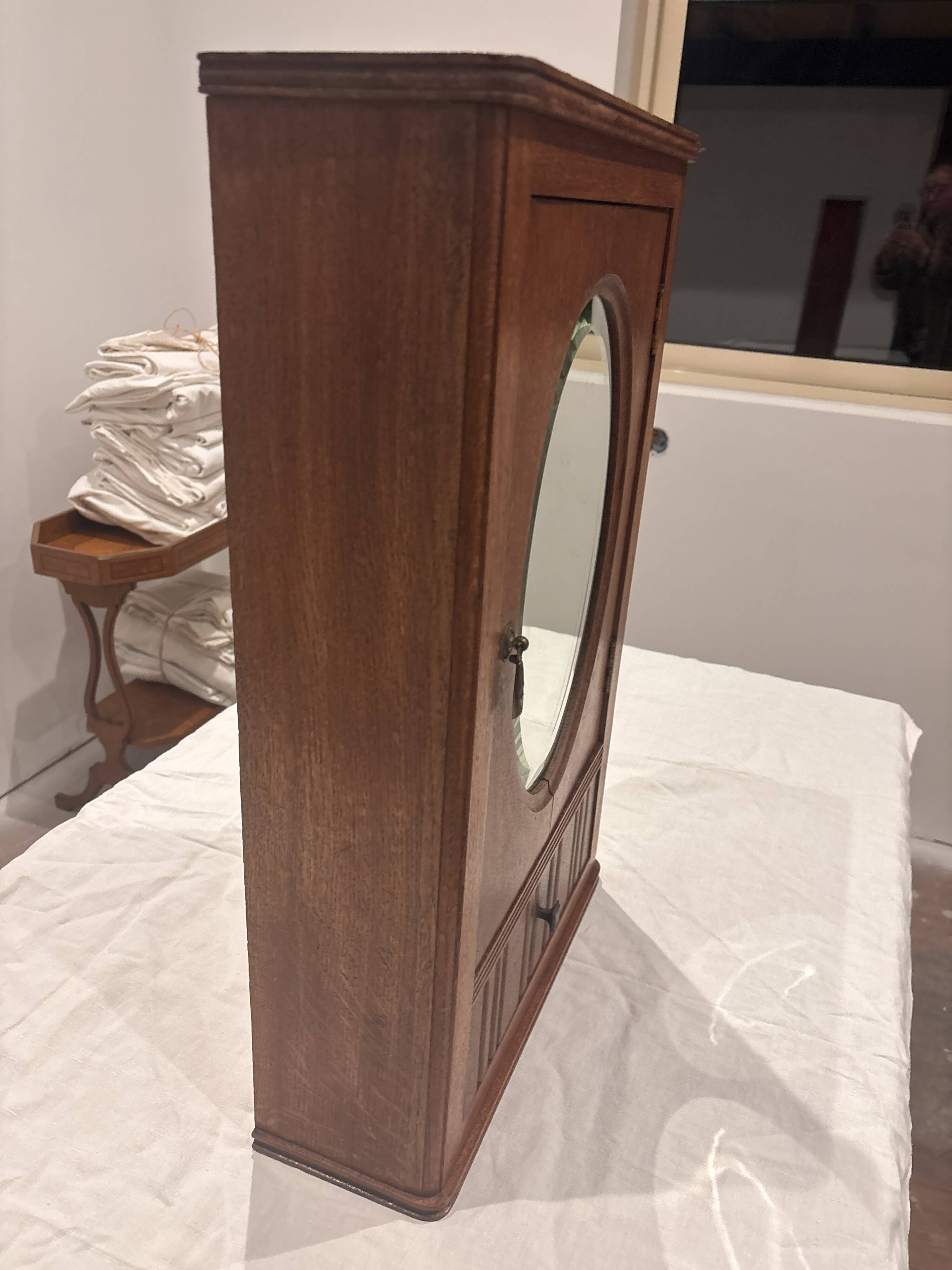 Wall cabinet with oval wall and drawer