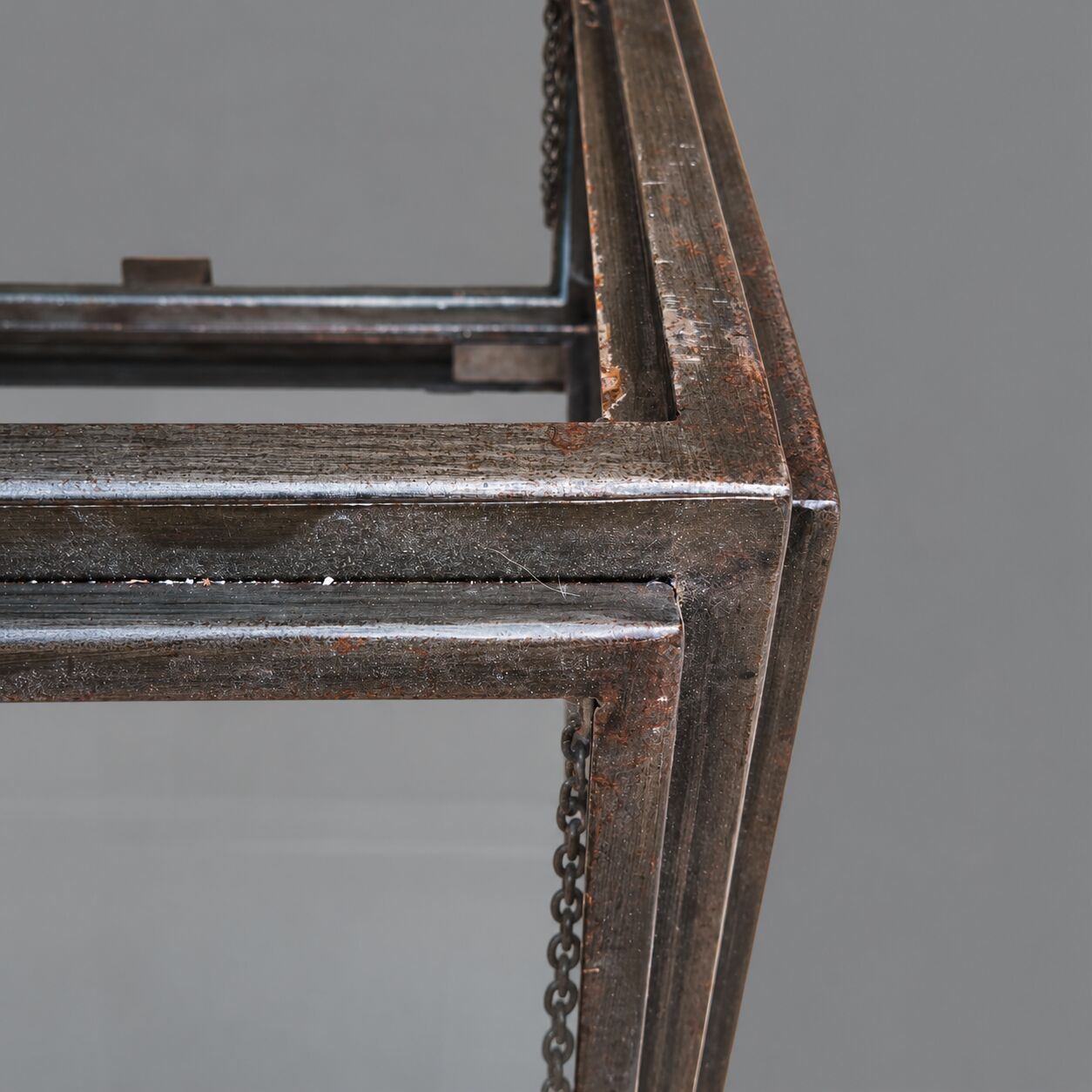 A showcase made of steel and glass, mounted on a custom-made steel base.