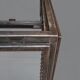 A showcase made of steel and glass, mounted on a custom-made steel base.