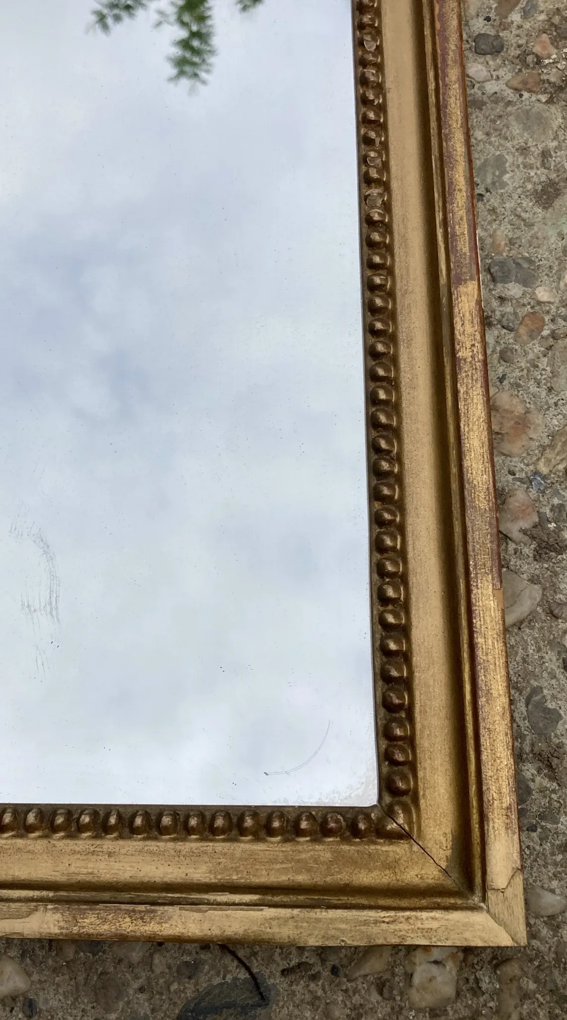 Antique mirror in wood and gilded stucco with a pediment - in the style of the 18th century.
