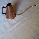Old watering can in red copper and brass