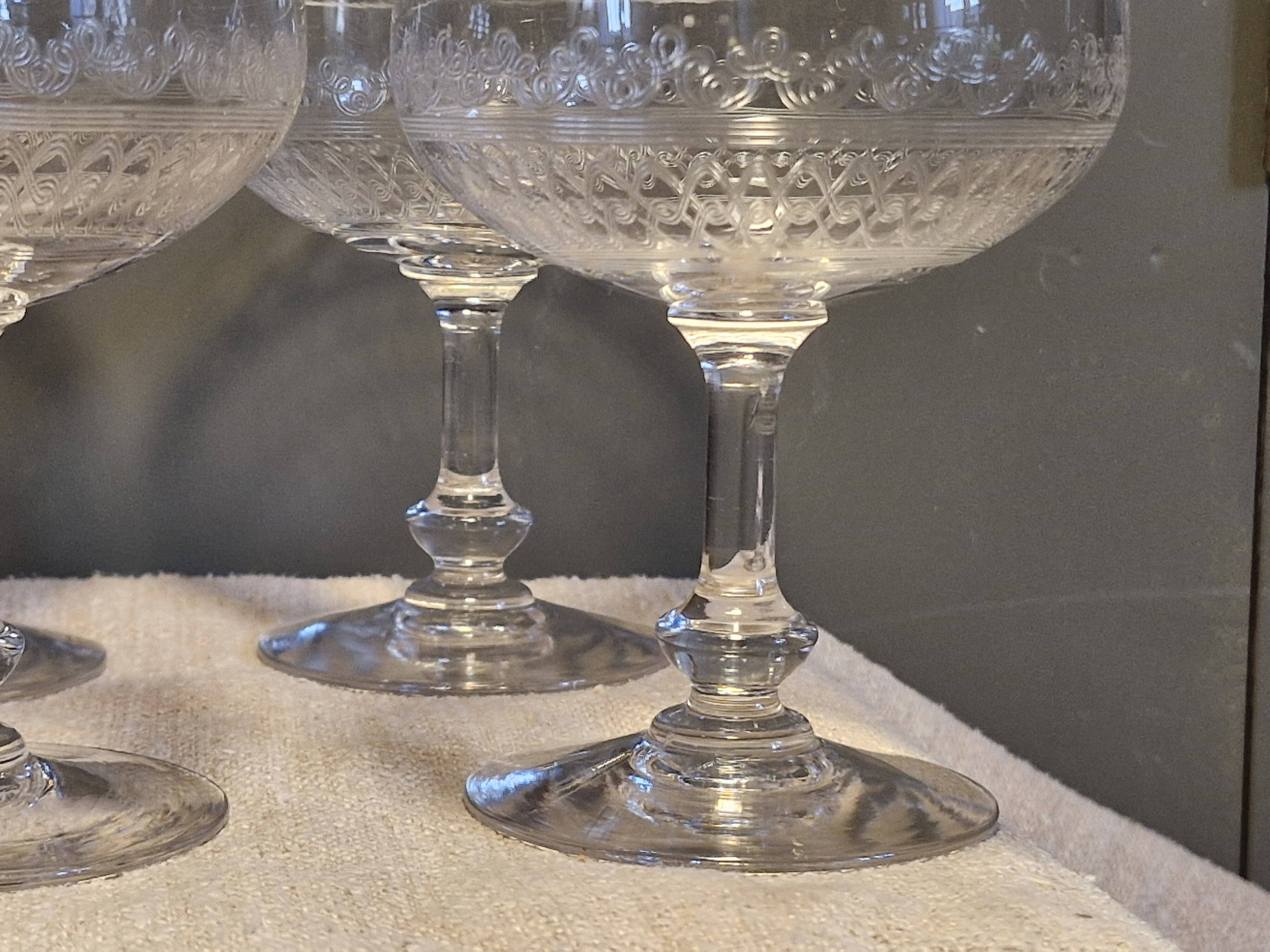 8 antique Baccarat crystal champagne coupes with engraved decoration.