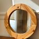 Round mirror in raw wood