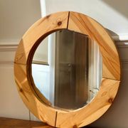 Round mirror in raw wood