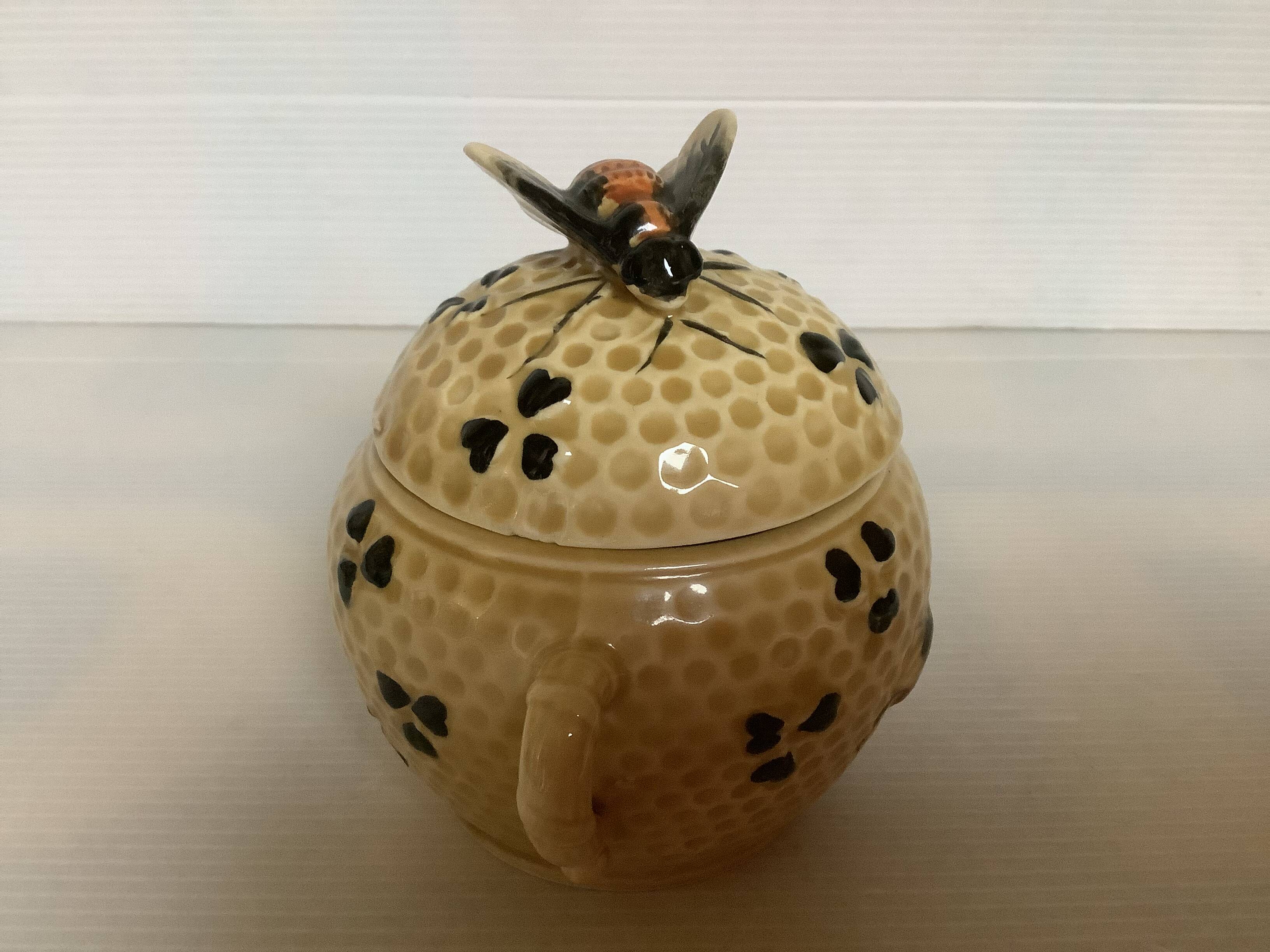 Old honey pot with bee decoration