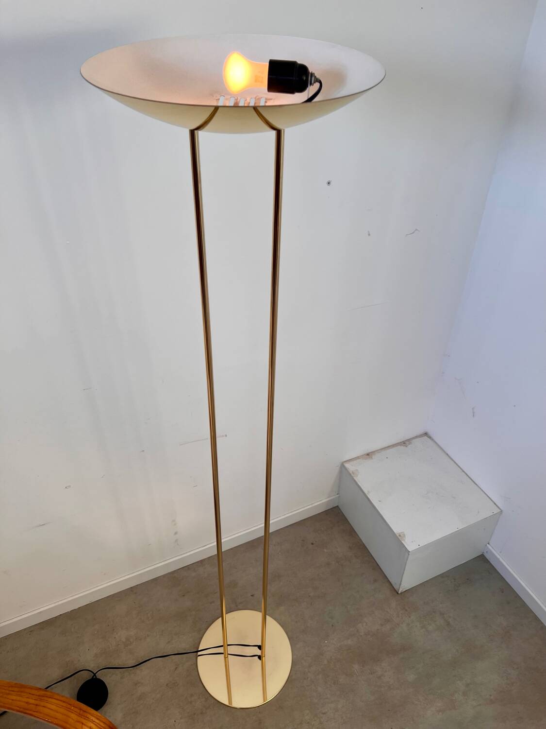 Old golden brass floor lamp with Italian design bulb from the 70s vintage