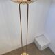 Old golden brass floor lamp with Italian design bulb from the 70s vintage
