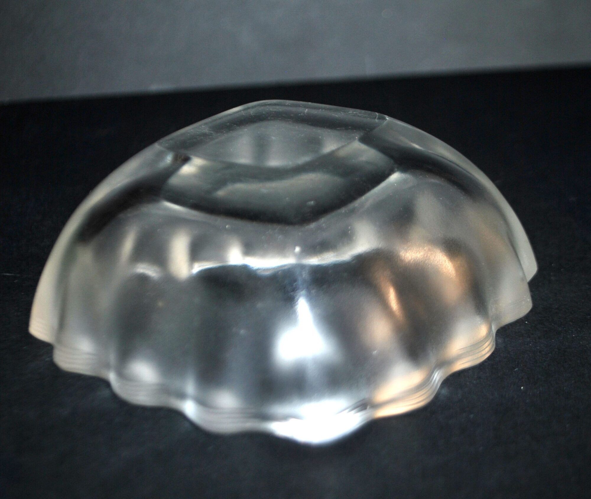 Lalique glass ashtray bowl with frosted finish, engraved with wave design, signed Lalique.