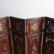 Asian screen in carved wood and mother-of-pearl marquetry.