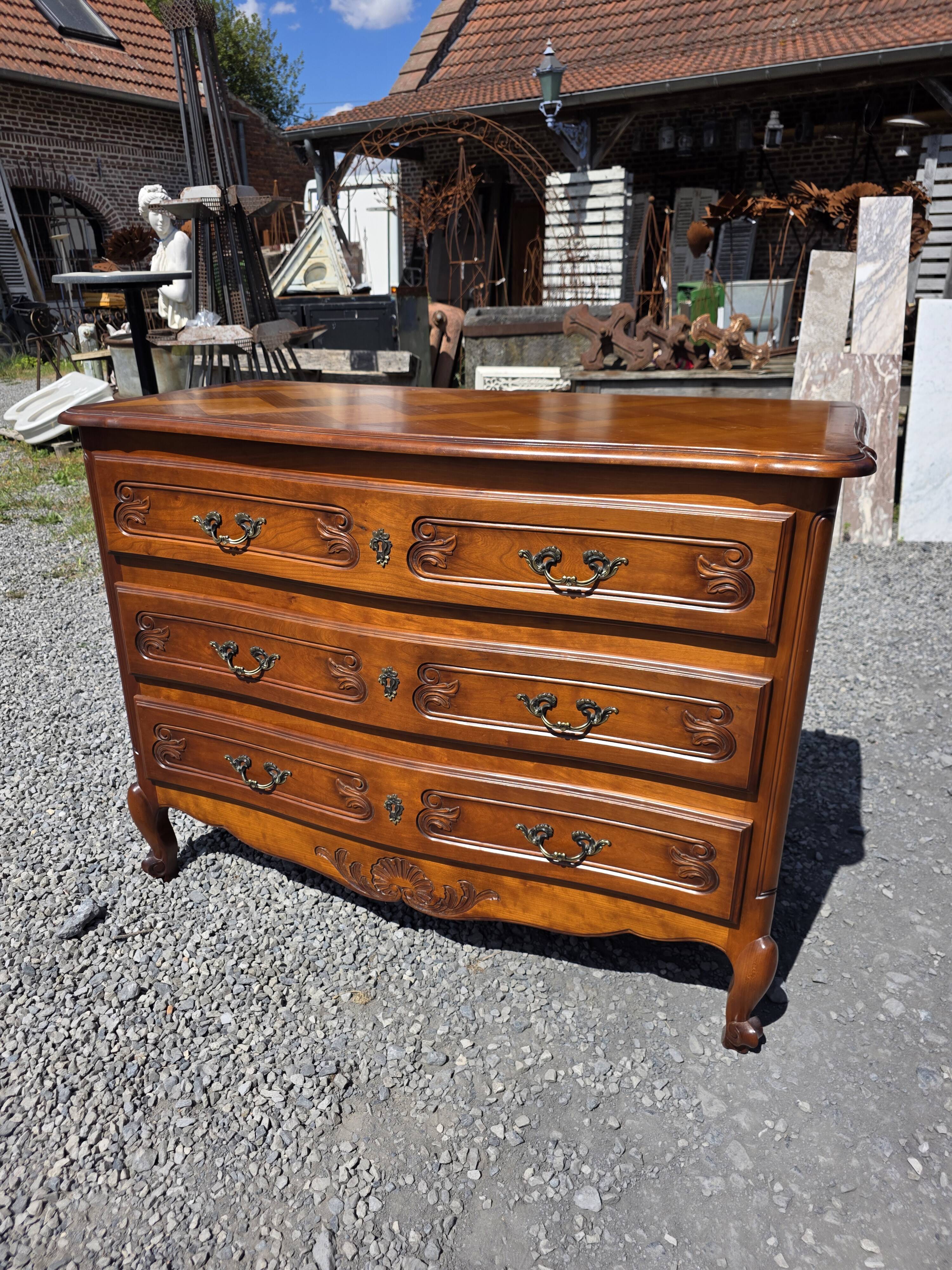Curved commode in Louis XV style made of cherry wood.