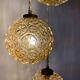 Suspension cascade trois feux globes vintage en verre ambré