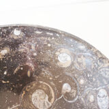 Empty pocket in fossilized black marble