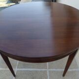 Round mahogany table with mahogany veneer and brass sabot foot.