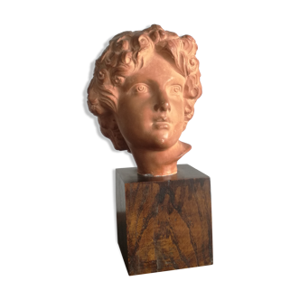 Ancient cherub bust on pedestal