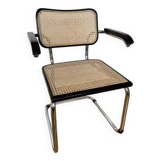 Cantilever dining chair with tubular frame and canework