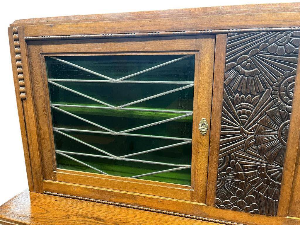 Vintage Art Deco display cabinet in wood with green stained glass.