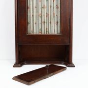 French Art Deco tall cabinet with glass door and hidden compartiment, ca. 1