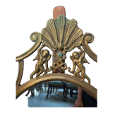 Miroir ovale en laiton doré , figures de chérubins et moulures