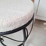 Black iron stool/pouf with its boucle fabric cushion.