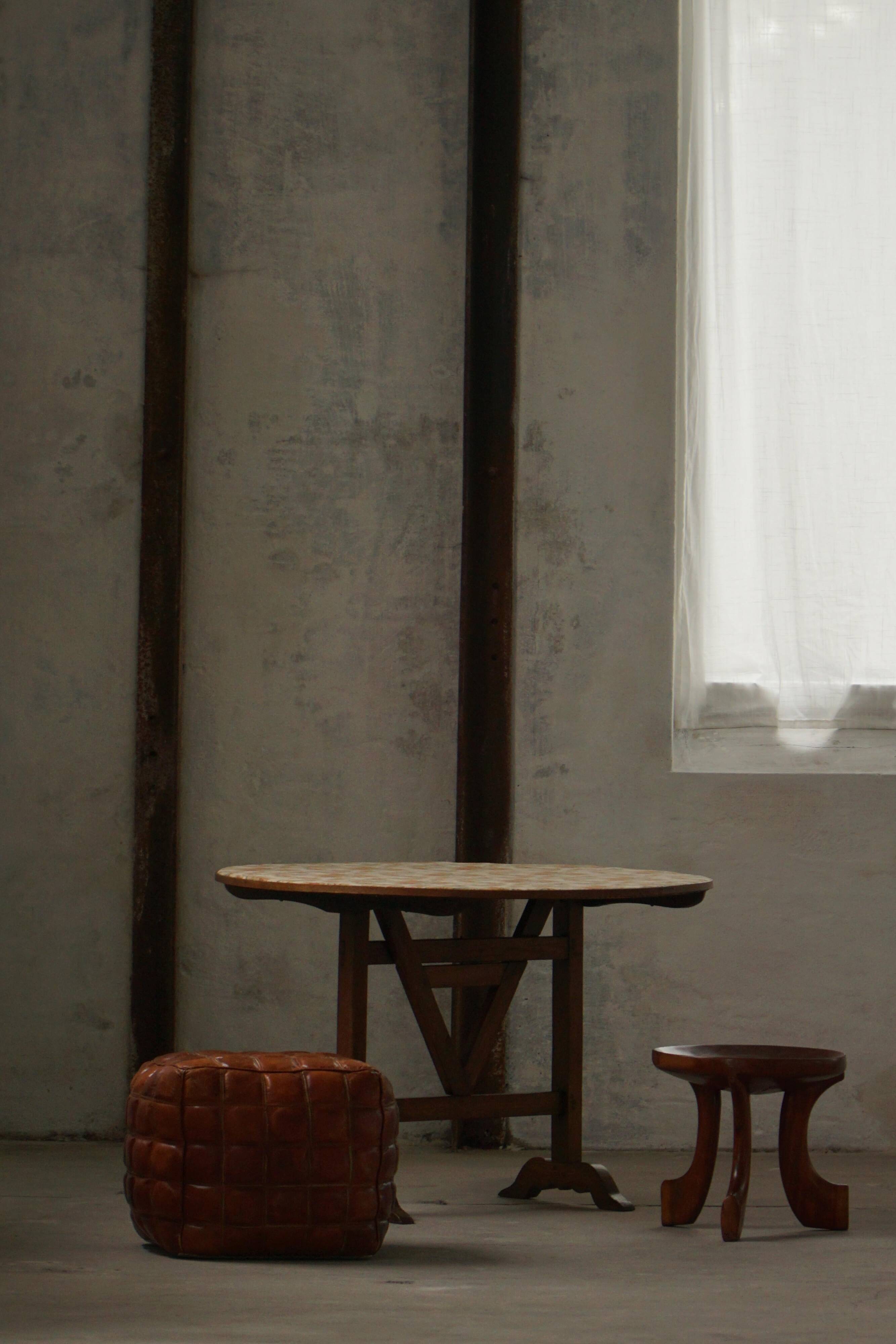 19th-century French round wine table with an adjustable top and floral textile surface.