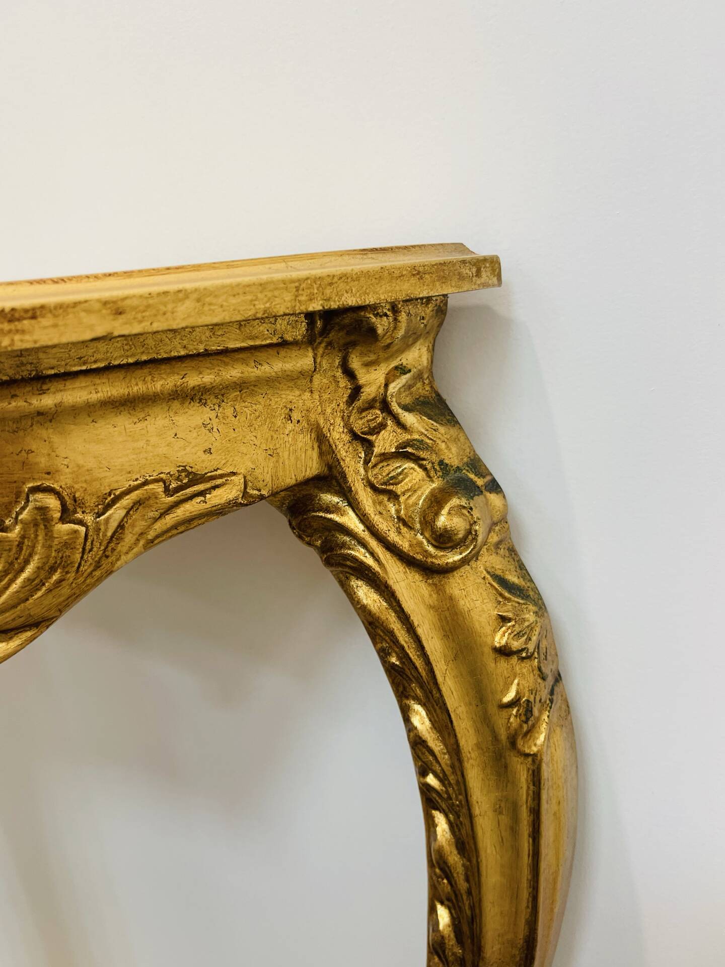 Golden console in Louis XV Rococo style made of resin.