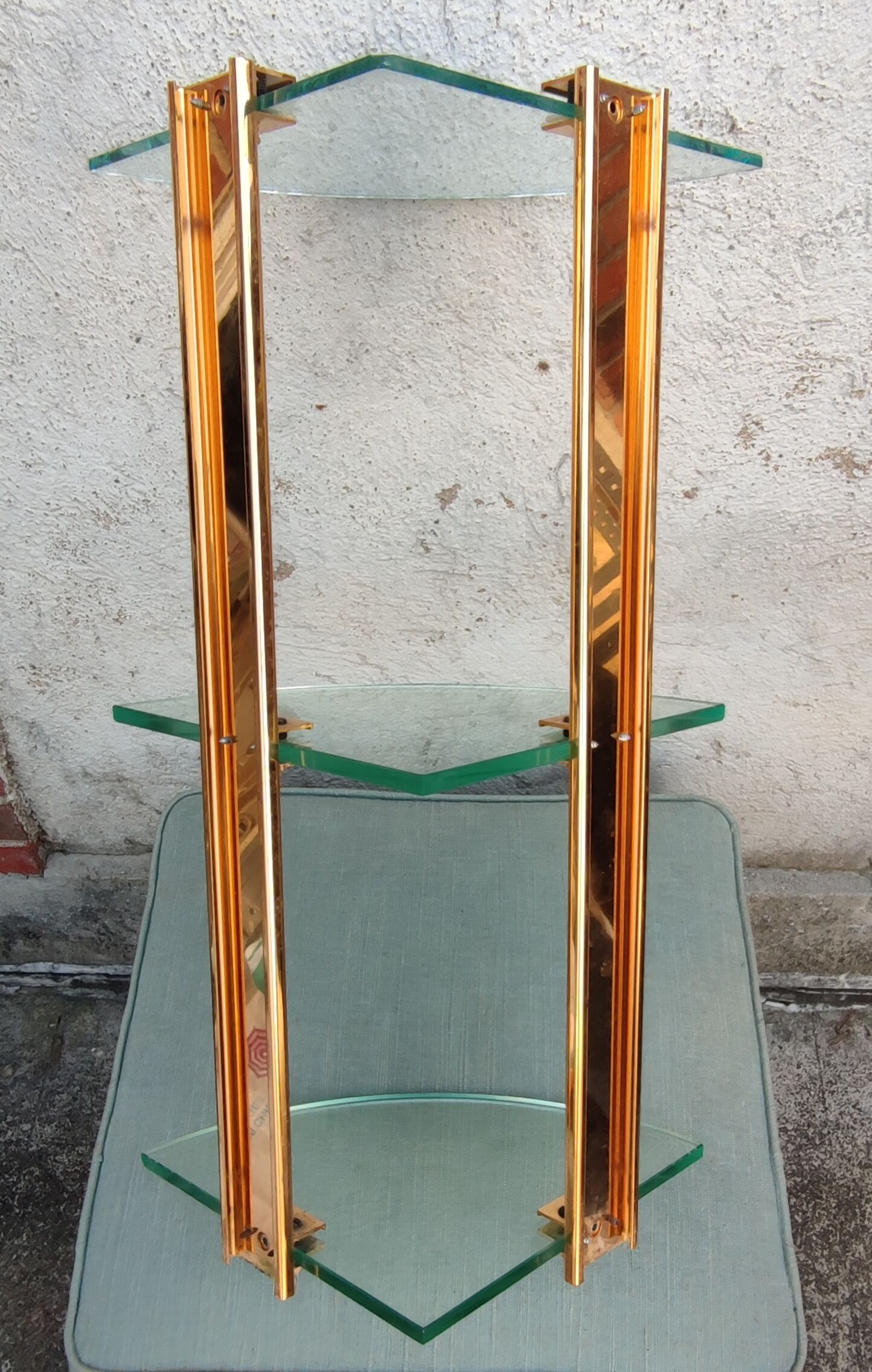 Wall shelf in gilded metal and glass/1980s
