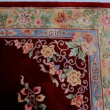 China wool fringed rug with floral pattern on deep plum background 393x274cm
