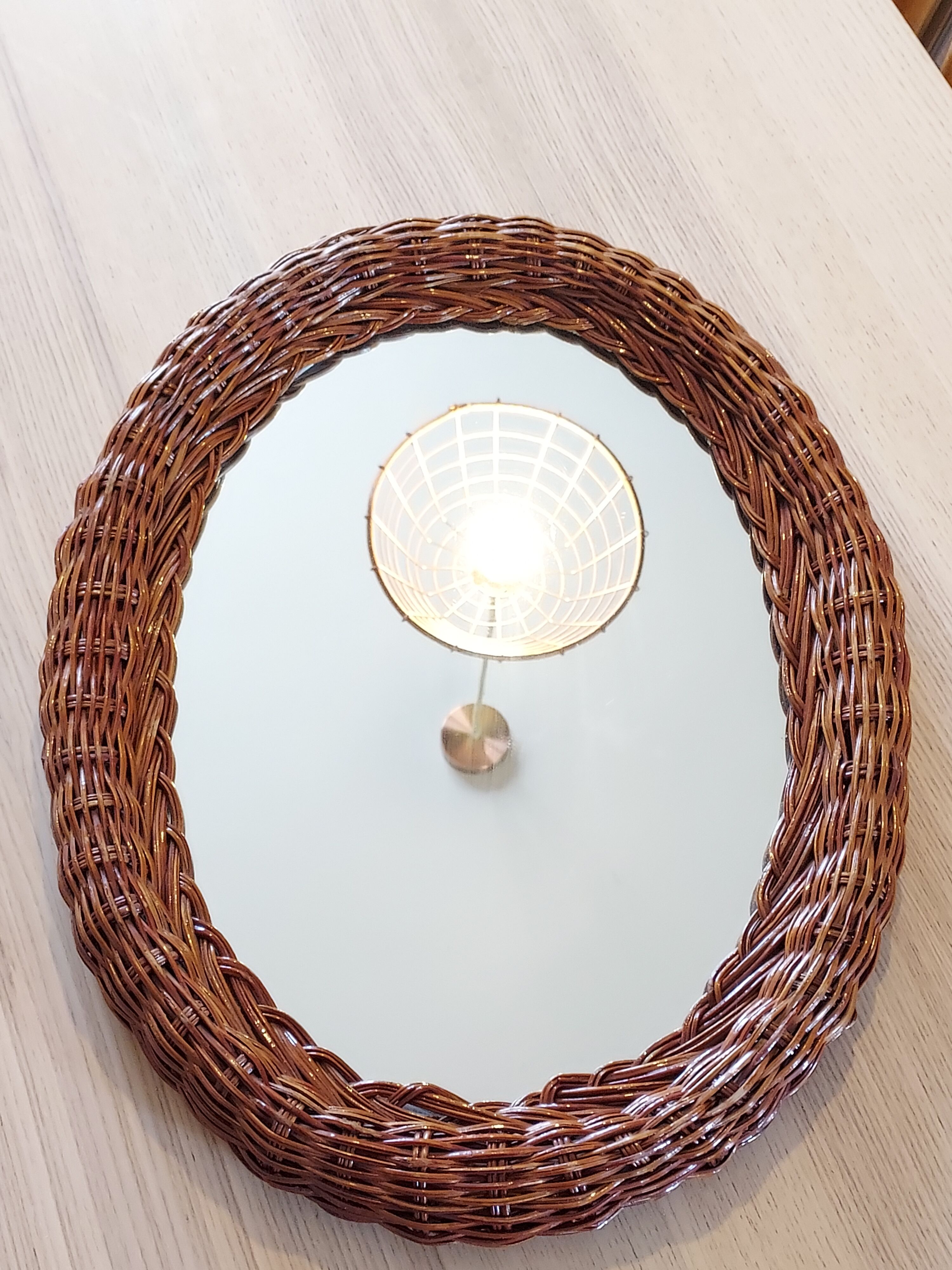 Oval mirror in dark rattan