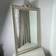 Large antique beveled mirror in carved wood painted with floral decoration and
