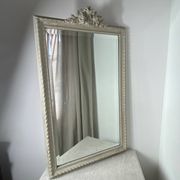 Large antique beveled mirror in carved wood painted with floral decoration and