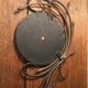 Round mirror surrounded by art deco style metal plants