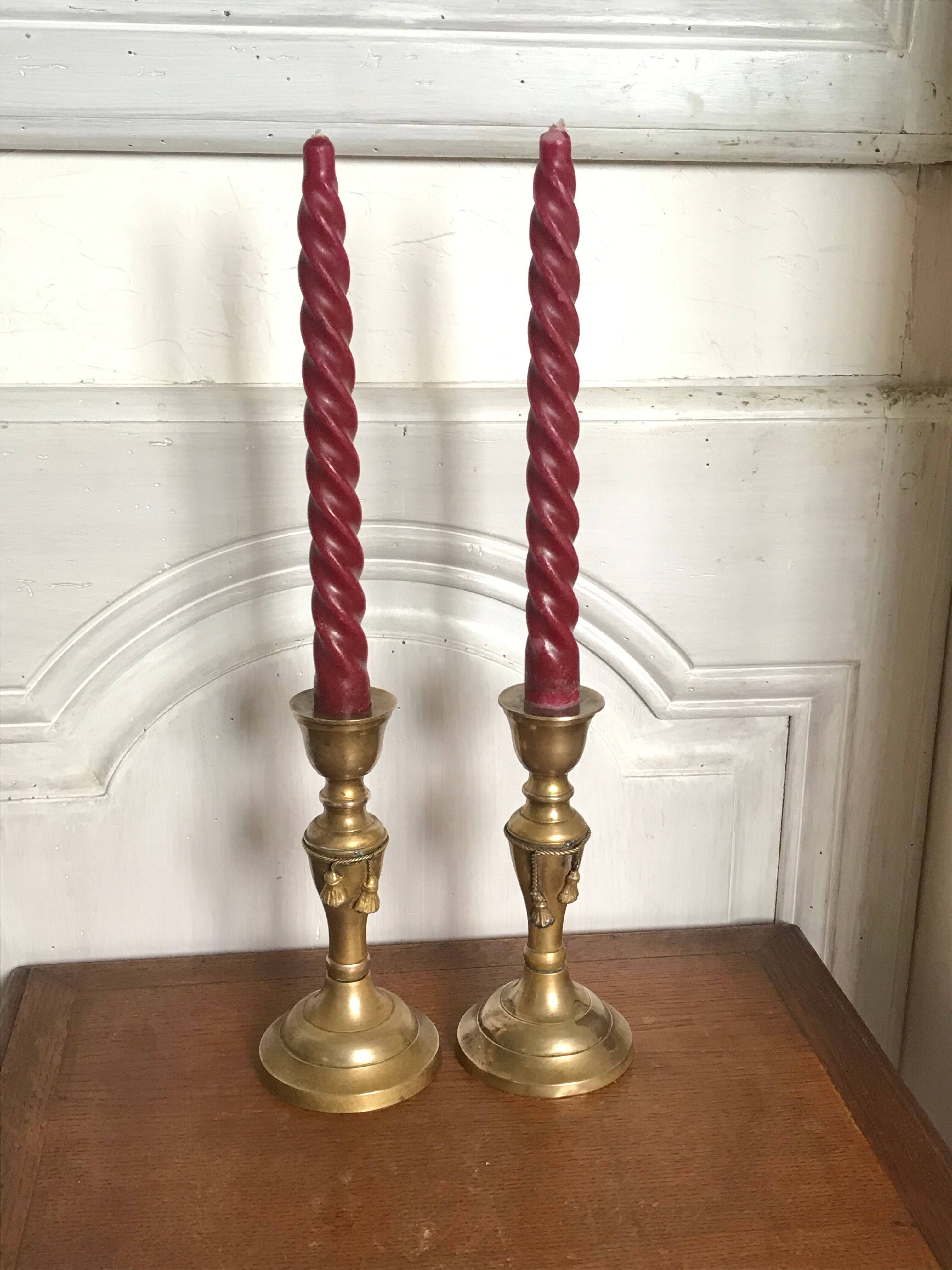 Pair of brass candlesticks with tassels