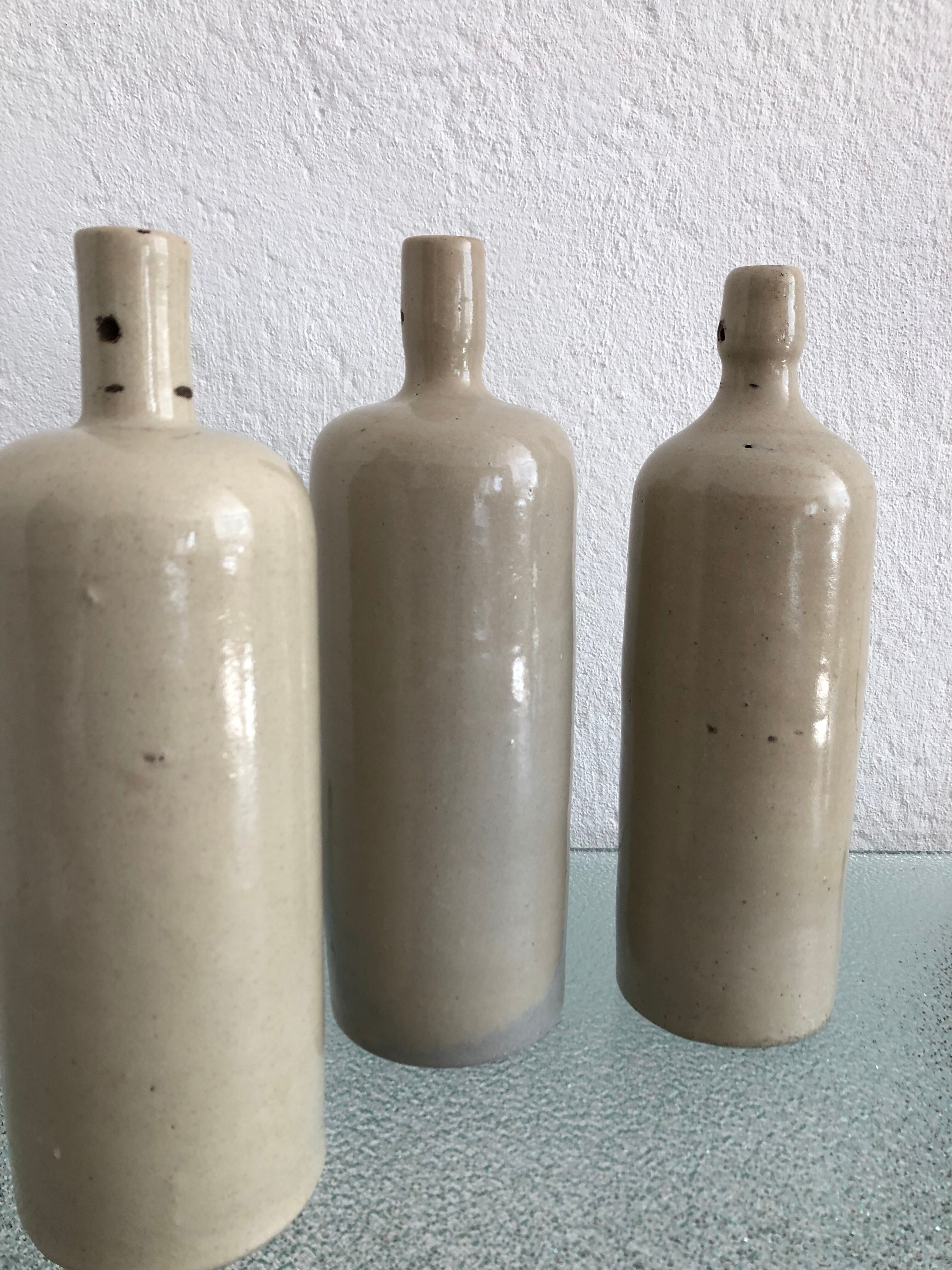 Trio of vintage stoneware bottles