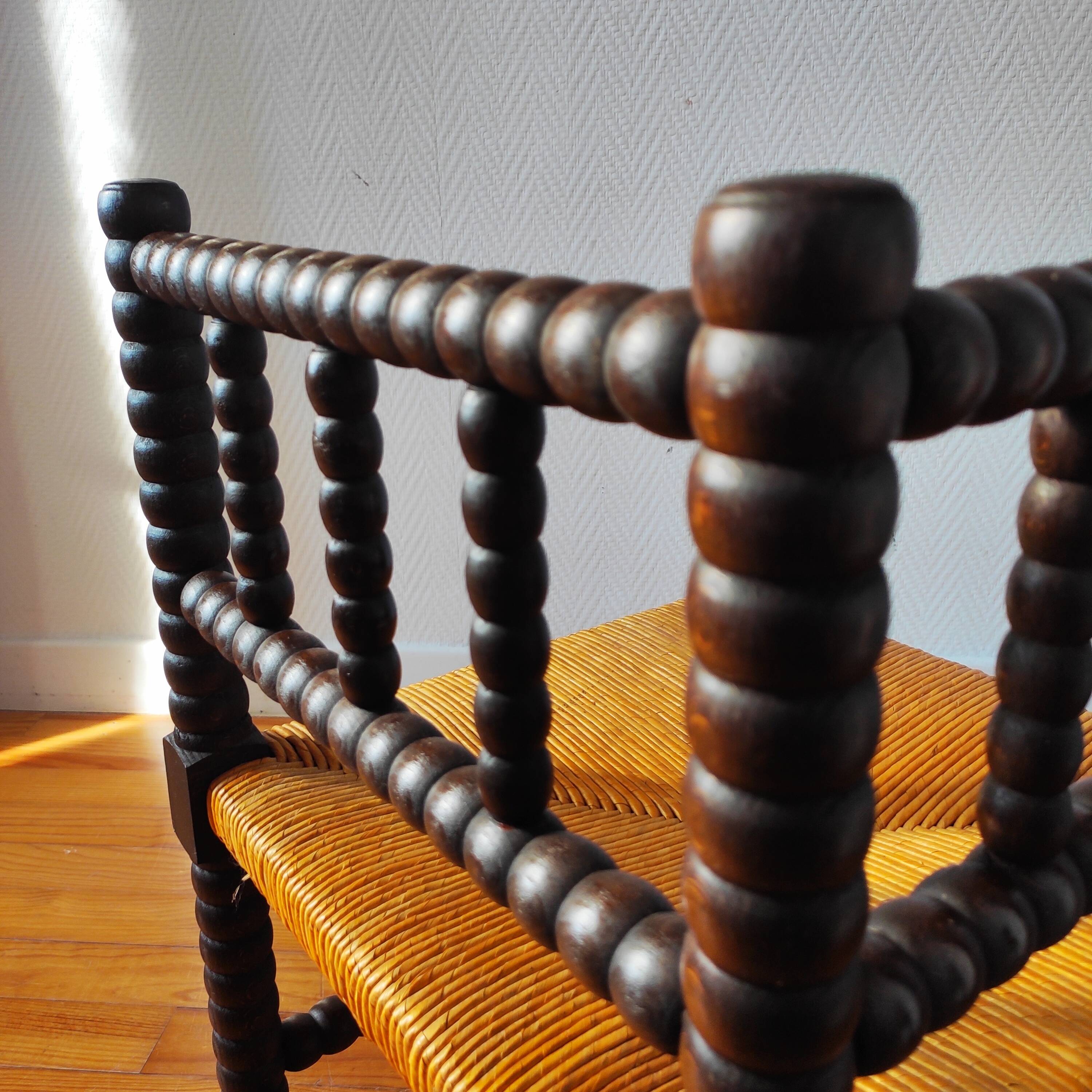 Antique corner chair made of turned wood.