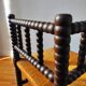 Antique corner chair made of turned wood.