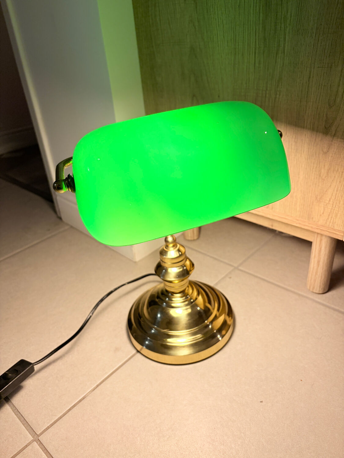 Gold and green banker’s desk lamp.