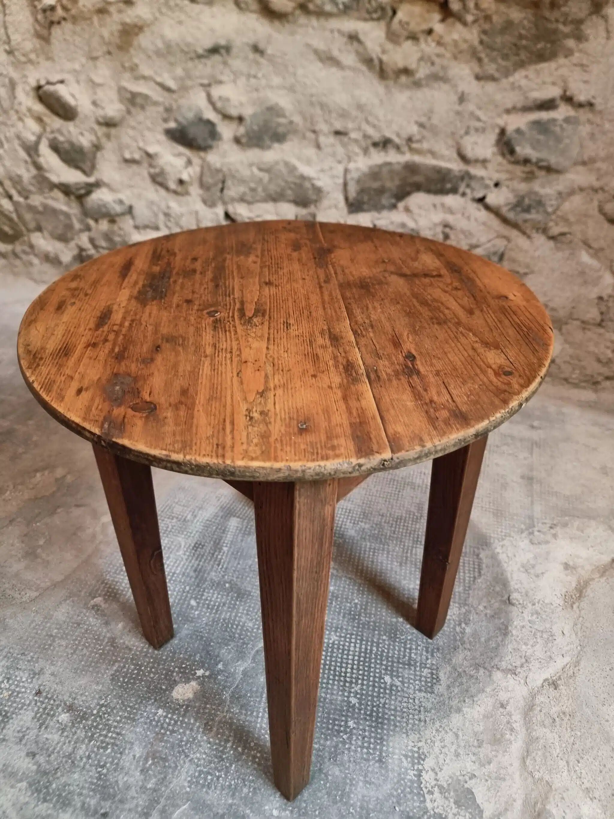 Antique round side table with oak legs and a pine top, circa 1900.