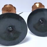Pair of flower-shaped candlesticks in black metal and copper