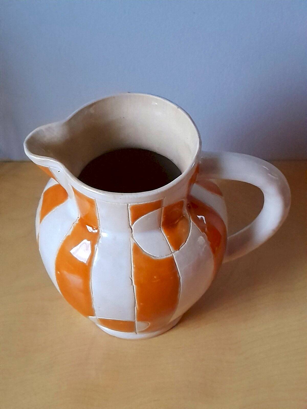 Old enamelled ceramic jug